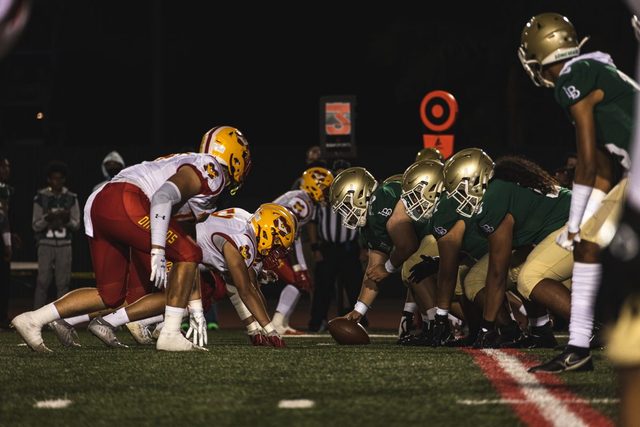 High school football players at the line of scrimmage during a game